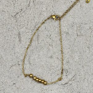 Goudkleurig enkelbandje met bolletjes