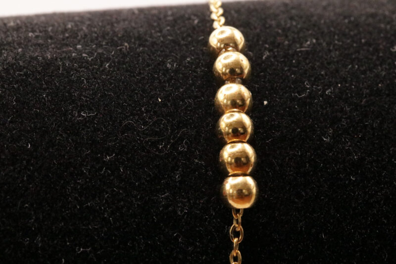 Goudkleurig enkelbandje met bolletjes