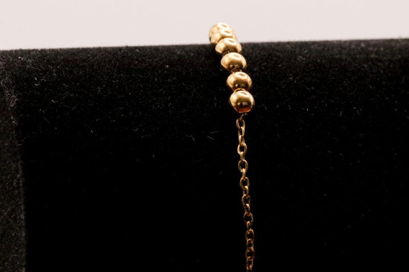 Goudkleurig enkelbandje met bolletjes