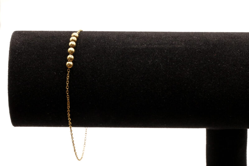 Goudkleurig enkelbandje met bolletjes