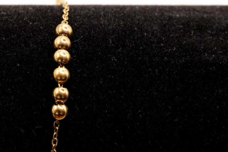 Goudkleurig enkelbandje met bolletjes